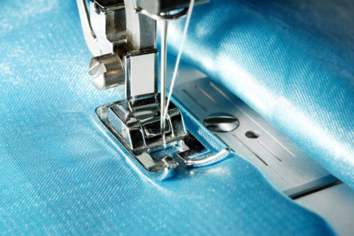 Sewing machine with blue cloth closeup